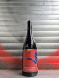 Bottle of Spoth Natur 58 natural wine with a bold red label featuring blue artistic graphics, set against a metallic background with red and black graffiti.